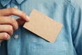 Young man who takes out craft blank business card from the pocket of his shirt Royalty Free Stock Photo
