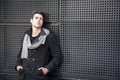 Young Man in a Winter Outfit Leaning on Metal Wall, Large Copyspace Royalty Free Stock Photo