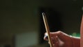 Young man wipes a cue with chalk ready to start game, close-up of hands. Poolroom.