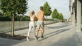 Young man and woman with athletic physiques work out together on sunny afternoon Royalty Free Stock Photo
