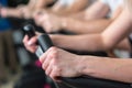 Young man and woman biking in the gym, exercising legs doing cardio workout cycling bikes Royalty Free Stock Photo