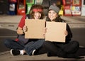 Young Man and Woman with Blank Cardboard Signs Royalty Free Stock Photo