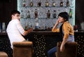 Young man and woman chatting at the bar Royalty Free Stock Photo