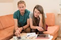 Young man and woman counting her money Royalty Free Stock Photo