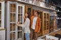 Young man and woman couple choosing cupboard at store market