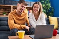 Young man and woman couple using laptop sitting on sofa at home Royalty Free Stock Photo