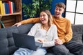 Young man and woman couple using laptop sitting on sofa at home Royalty Free Stock Photo