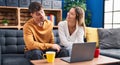 Young man and woman couple using laptop sitting on sofa at home Royalty Free Stock Photo