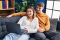 Young man and woman couple using laptop sitting on sofa at home Royalty Free Stock Photo