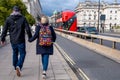 Young Man and Woman Couple Walking Accross Waterloo Bridge Holding Hands
