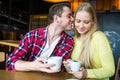 Young man and woman drinking coffee in a restaurant. Young man and woman drinking coffee on a date. man and woman on a date