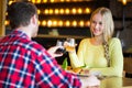 Young man and woman drinking wine in a restaurant. Young man and woman drinking wine on a date. man and woman on a date