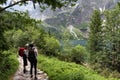 Young man and woman exploring road in the mountain. Tatra National Park