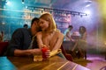 Young man and woman flirting in the bar, enjoying drinks and conversation. Love, couple, romance concept Royalty Free Stock Photo