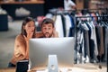 Young man and woman in front of computer desktop looking at screen looking surprised Royalty Free Stock Photo