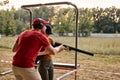 young man and woman in goggles and headset preparing to shoot, ready to shoot.