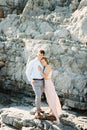 Young man and woman hugging standing on the rocks Royalty Free Stock Photo