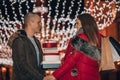 Young man and woman are laughing, walking and buying presents for their darlings and each other