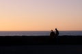 A young man and a woman looks out over the ocean during sunset in MalmÃÂ¶, Sweden