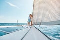 Young man and woman in love sailing sailboat yacht