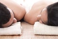 Young man and woman lying on towel to take spa Royalty Free Stock Photo