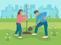 A young man and woman plant a tree in the Park