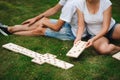Young man and woman playing giant dominoes in the Park on the grass