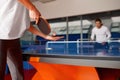 Young man and woman playing ping pong, focus on racket Royalty Free Stock Photo