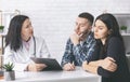 Young man and woman reading doctor`s prescriptions for infertility cure Royalty Free Stock Photo