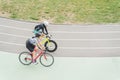 Young man and woman are riding on bike track in athletic wear on the stadium in Kiev, Ukraine Royalty Free Stock Photo