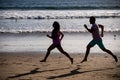 Young man and woman running jogging along the sea. Couple running on beach. Royalty Free Stock Photo