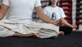 Young man and woman sits in lotus position and meditates. Couple does yoga. Close-up.