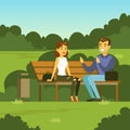 Young man and woman sitting on the bench in the park and talking, flat vector illustration Royalty Free Stock Photo