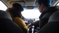 Young man and woman sitting in the car. The man explains her how to start the car Royalty Free Stock Photo