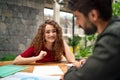 Young man and woman sitting indoors in green office, business meeting concept. Royalty Free Stock Photo