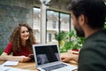 Young man and woman sitting indoors in office, business meeting concept. Royalty Free Stock Photo