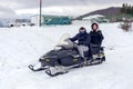 Young man and woman sitting on a snowmobile close-up Greece