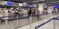 Young man and woman standing in front of 2 different check-in counters in airport.Concept of efficient operations Royalty Free Stock Photo