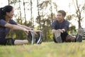 Young man and woman stretching in the park