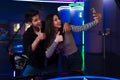 Young man and woman taking selfie on cellphone while playing air hockey