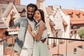 Young man and woman taking selfie on smartphone with old buildings on the background Royalty Free Stock Photo