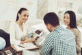 Young Man and Woman in Travel Agency with Manager. Royalty Free Stock Photo