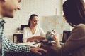 Young Man and Woman in Travel Agency with Manager. Royalty Free Stock Photo