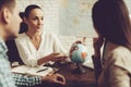 Young Man and Woman in Travel Agency with Manager. Royalty Free Stock Photo