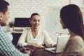 Young Man and Woman in Travel Agency with Manager. Royalty Free Stock Photo