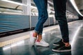 Young man and woman use underground. Couple in subway. Cut view of man and woman stand in front of each other. Fast Royalty Free Stock Photo