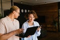 Young man and woman using laptop while working together in office Royalty Free Stock Photo