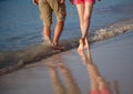 Young man and woman walking along the seacoast Royalty Free Stock Photo