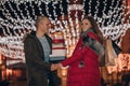 Young man and woman are walking and buying presents for their darlings and each other