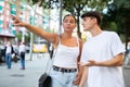 Young man and woman walking outside, pointing finger Royalty Free Stock Photo
